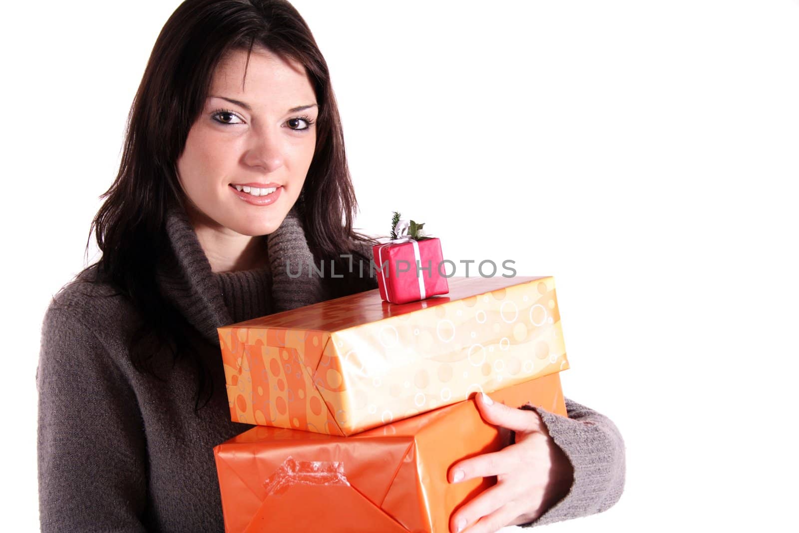 A handsome young woman holding a pile of presents. All isolated on white background.