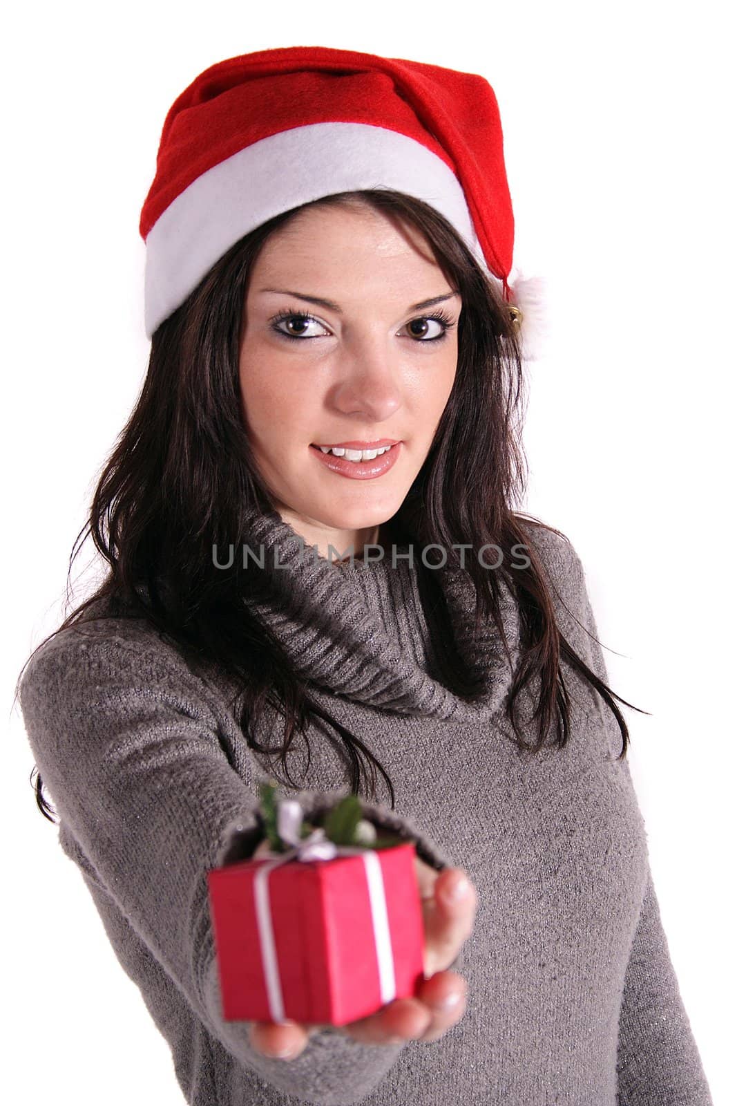 A handsome young woman holding a small red present. All isolated on white background.