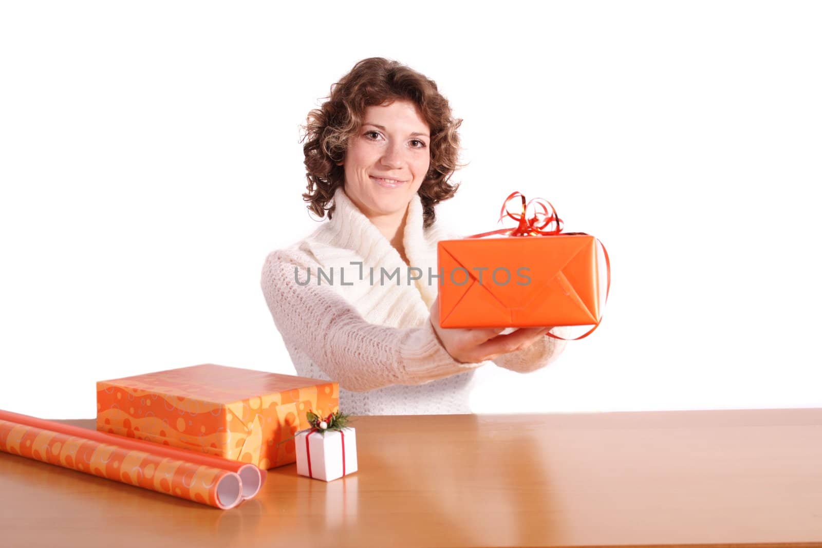 A handsome young woman wrapping presents. All isolated on white background.