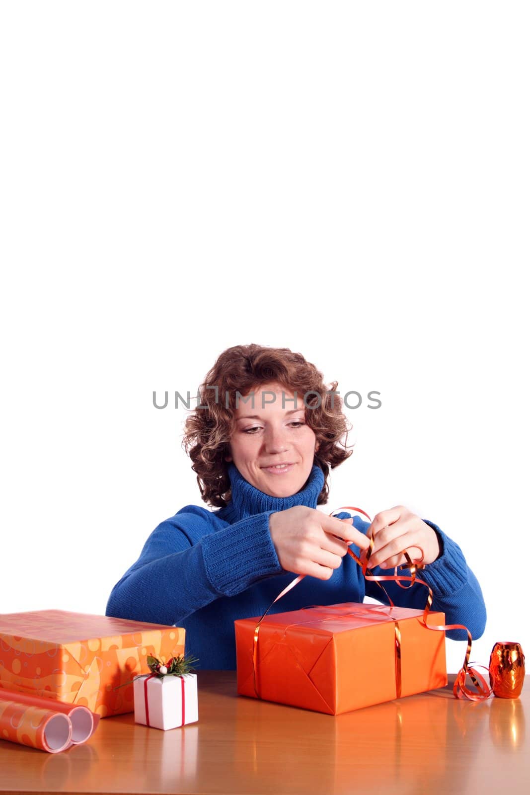 A handsome young woman wrapping presents. All isolated on white background.