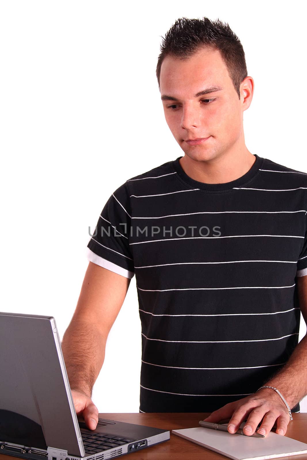 An ambitious student working at his notebook computer. All isolated on white background.