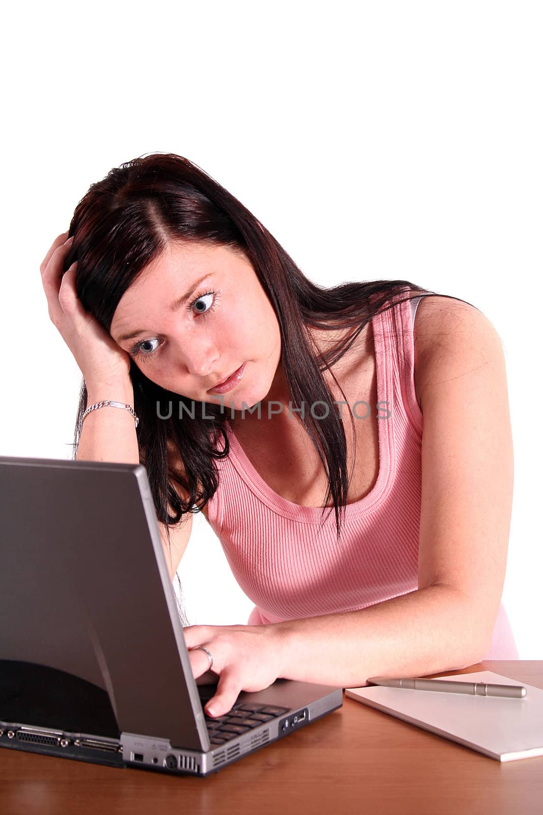 A young handsome student working at her notebook computer. All isolated on white background.