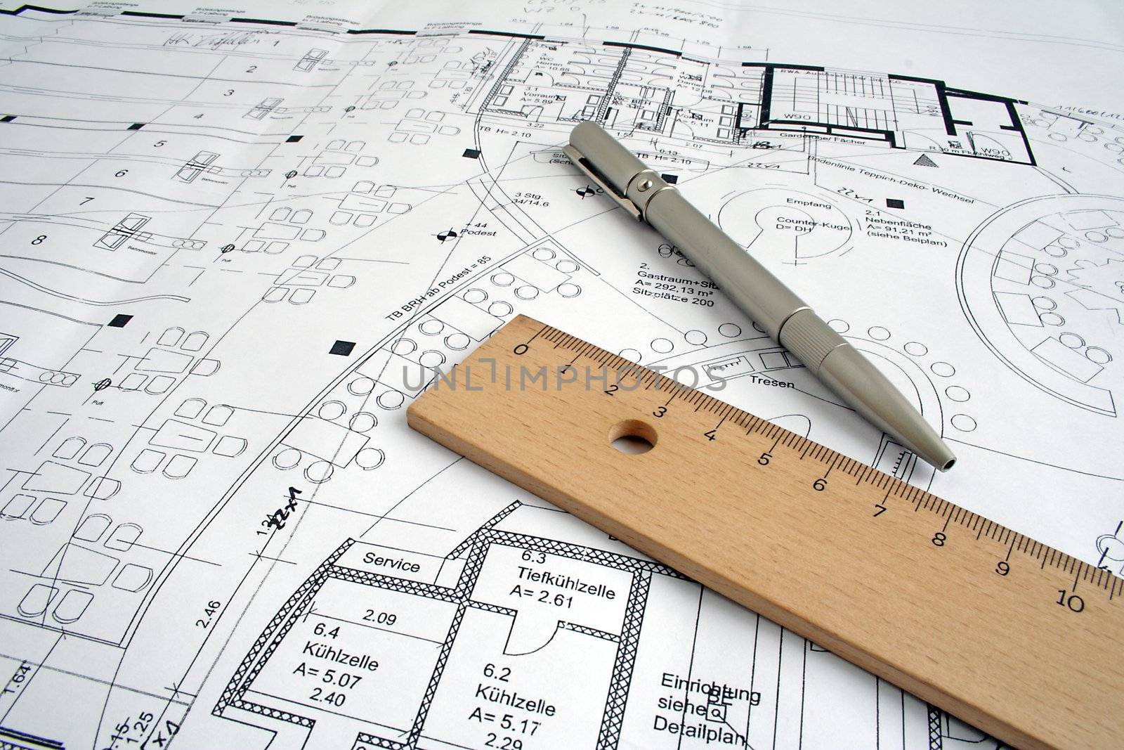 Typical utensils of a draftsman lying on a ground plan.