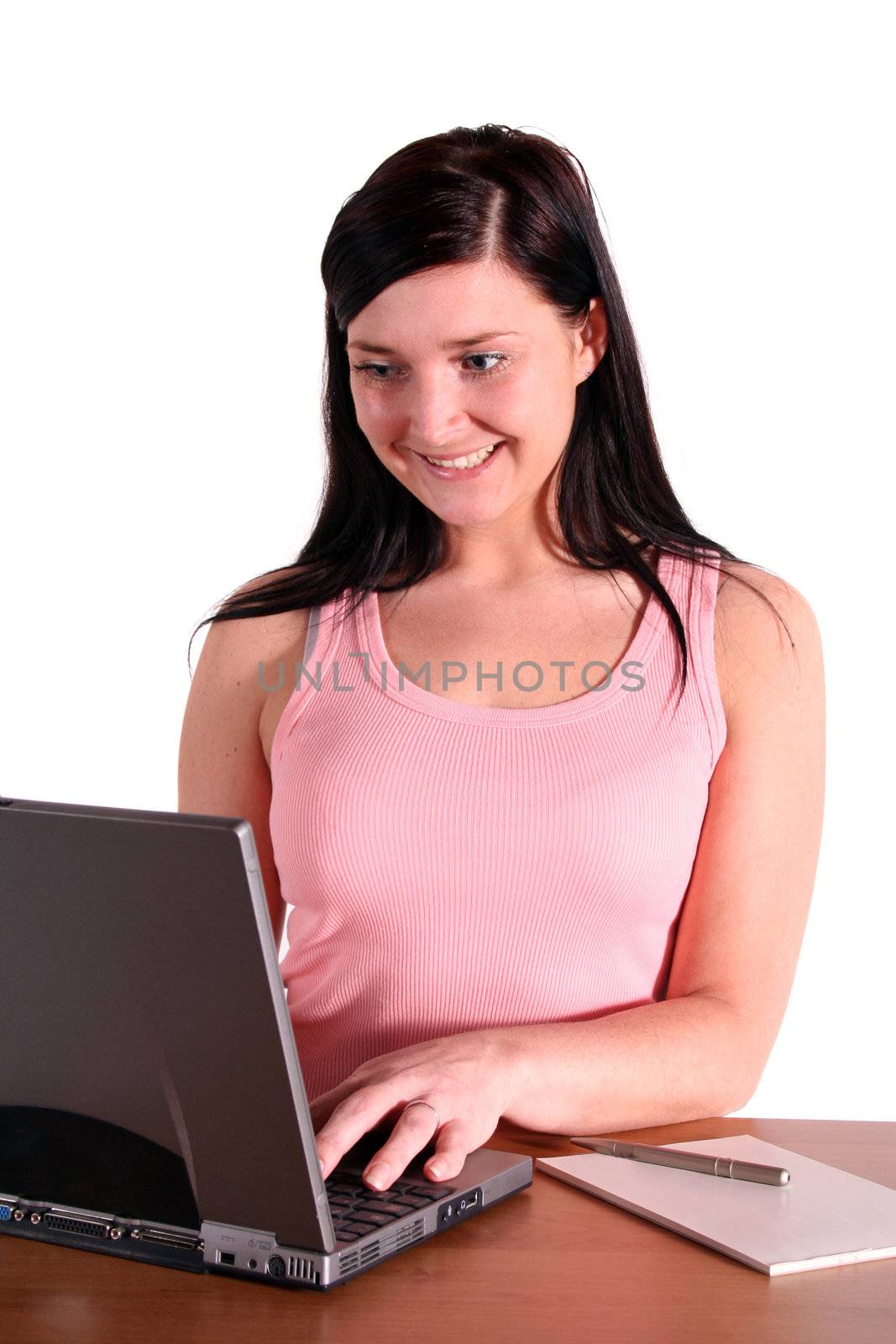 A young handsome student working at her notebook computer. All isolated on white background.