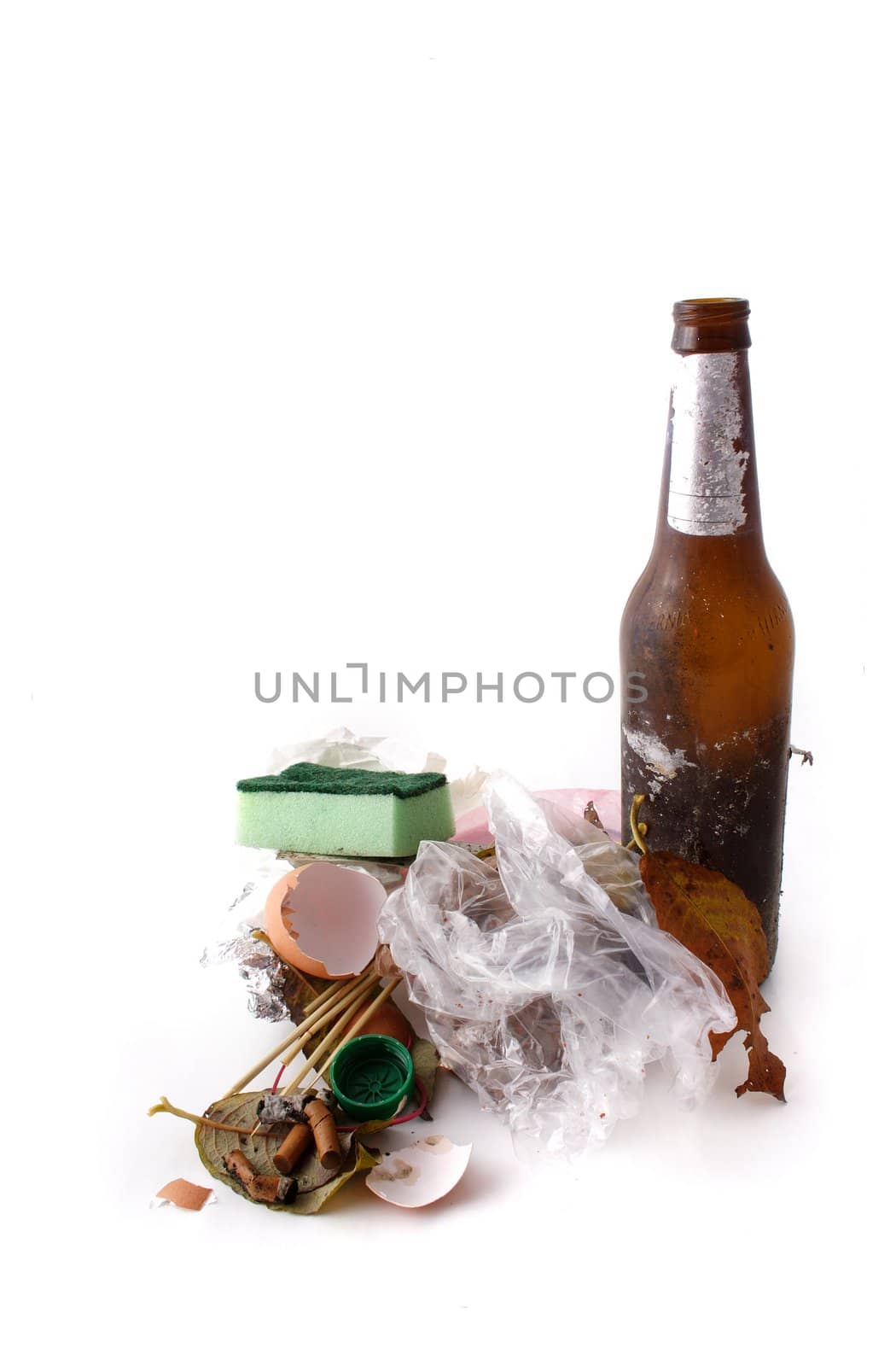 A dirty pile of trash lying in front of white background.