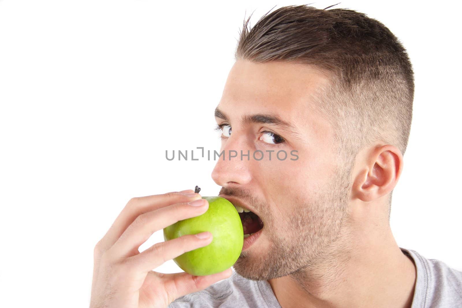 A handsome man eating an apple. All isolated on white background.