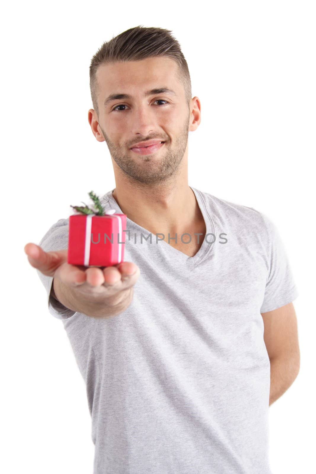 A handsome man handovers a small present. All isolated on white background.