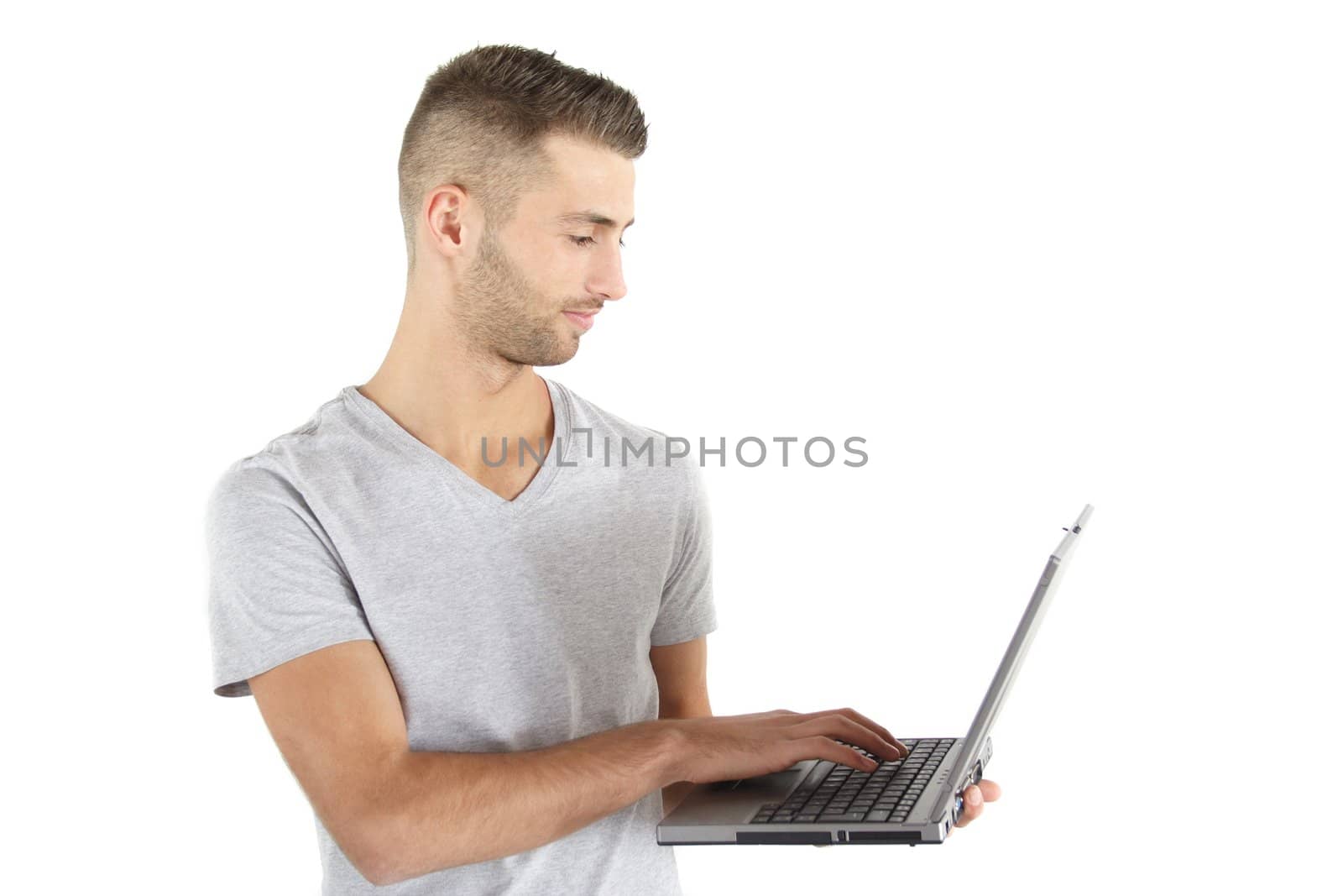 A young handsome man working with his notebook computer. All isolated on white background.