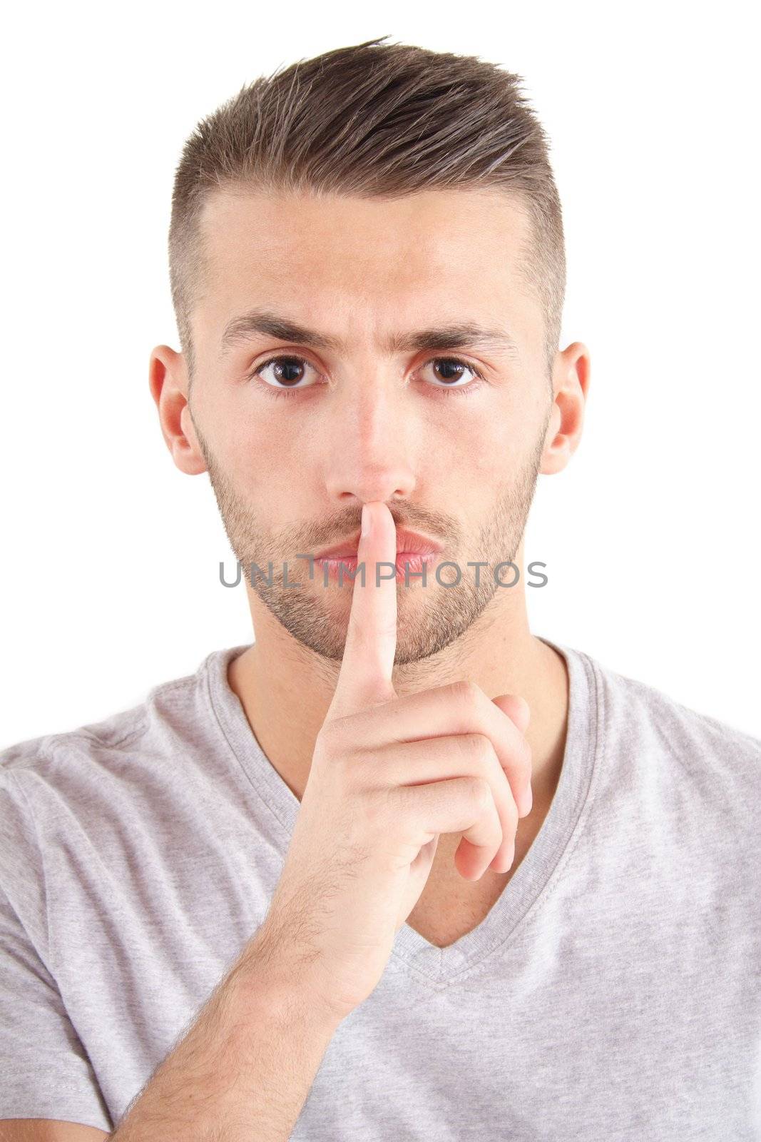 A handsome man asks for silence. All isolated on white background.