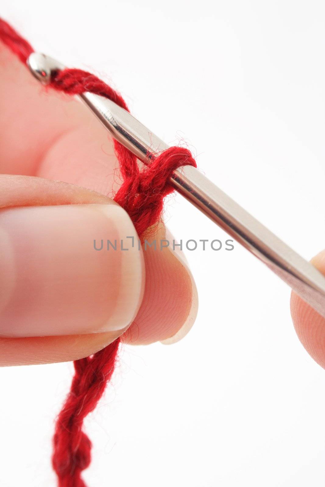 A human hand crocheting. All isolated on white background.