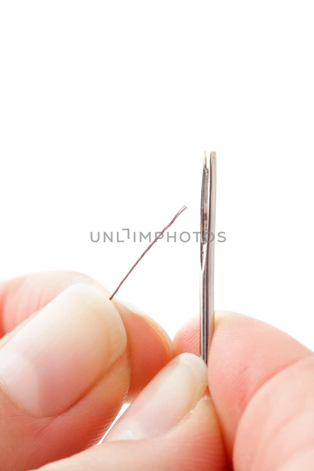 A human hand threading a thread. All isolated on white background.