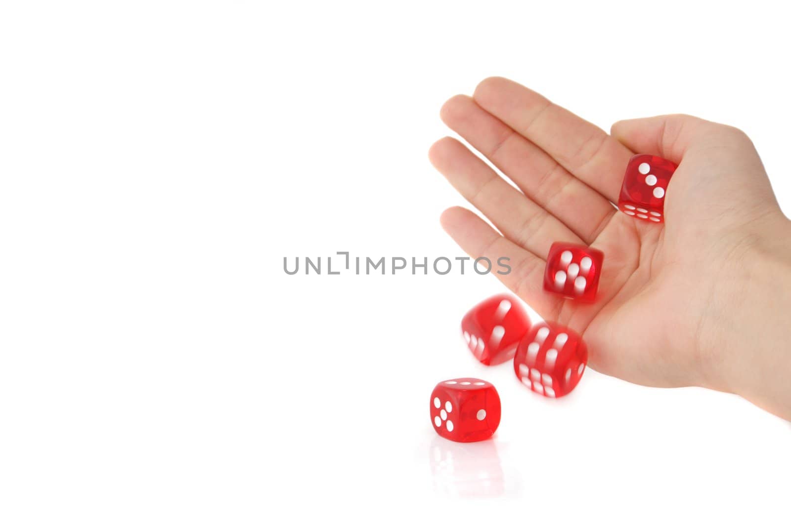 A human hand rolling several dices. All isolated on white background.