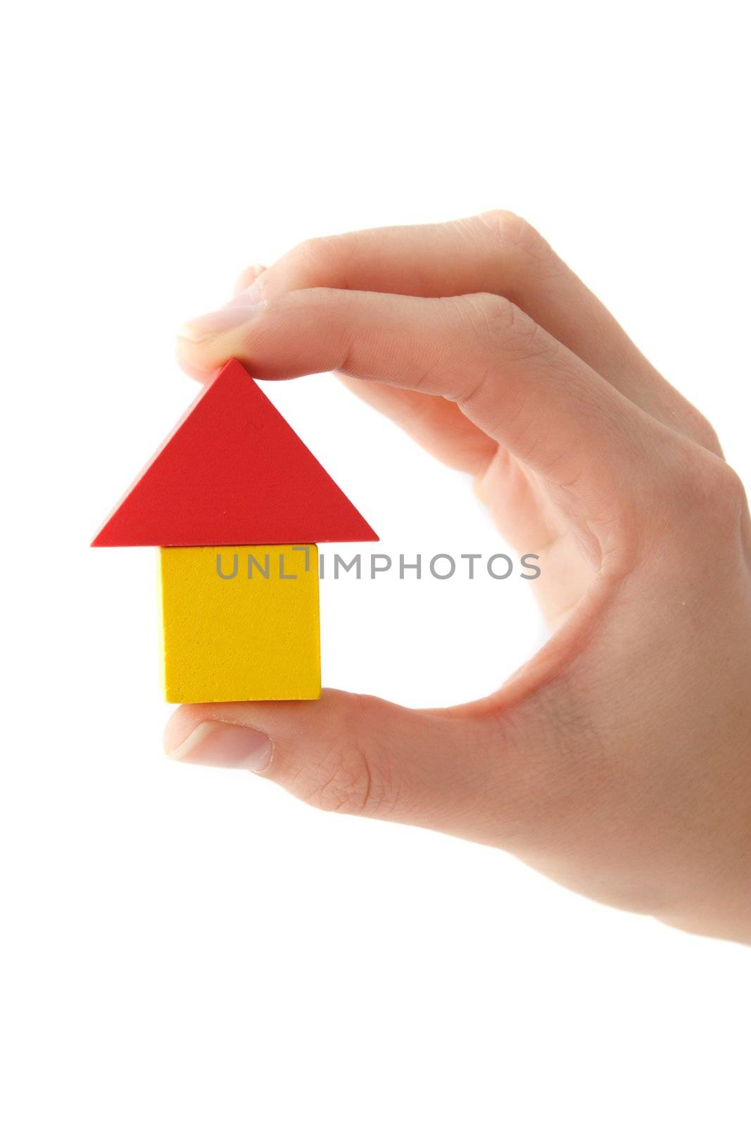 A human hand holding a stylized house out of colored blocks. All isolated on white background.