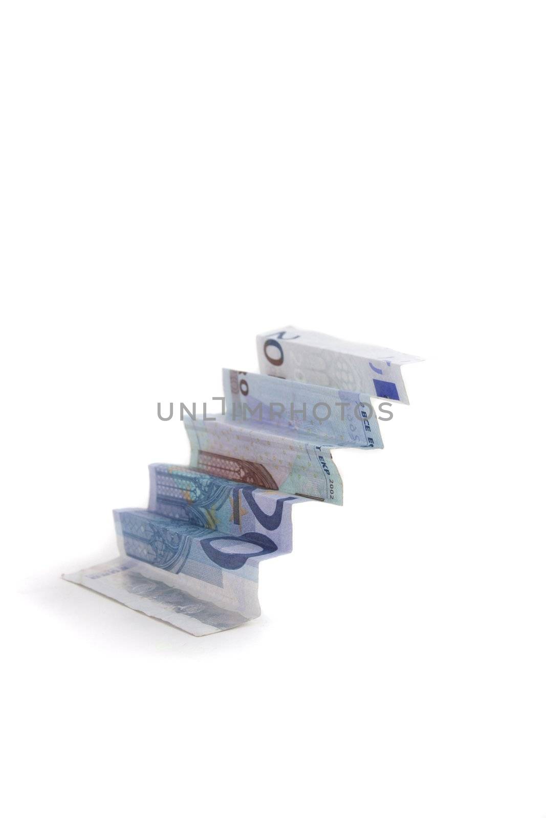 A folded bank note looks like stairs. All isolated on white background.