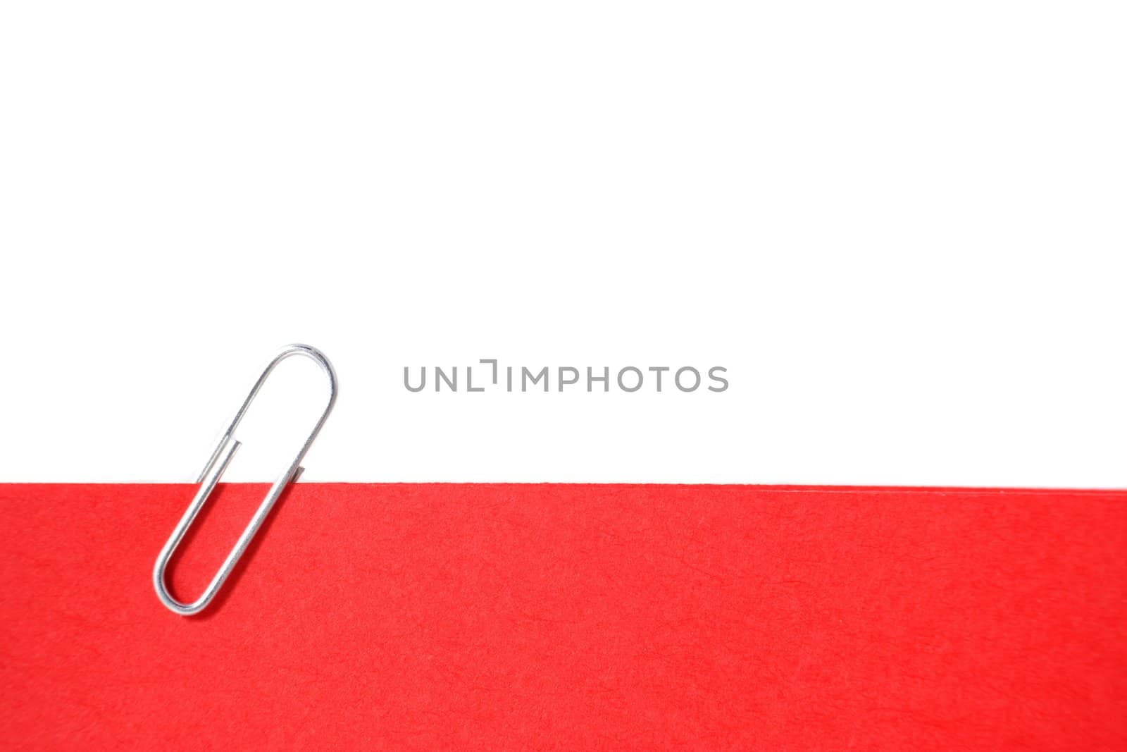 A single paperclip holding a red note. All isolated on white background.