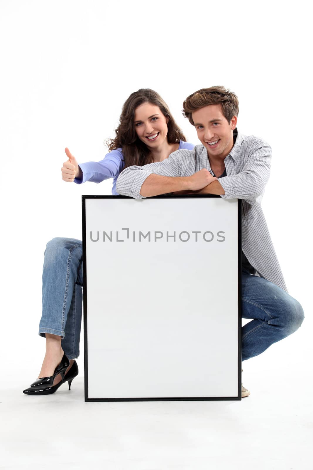 Couple crouching by empty frame by phovoir