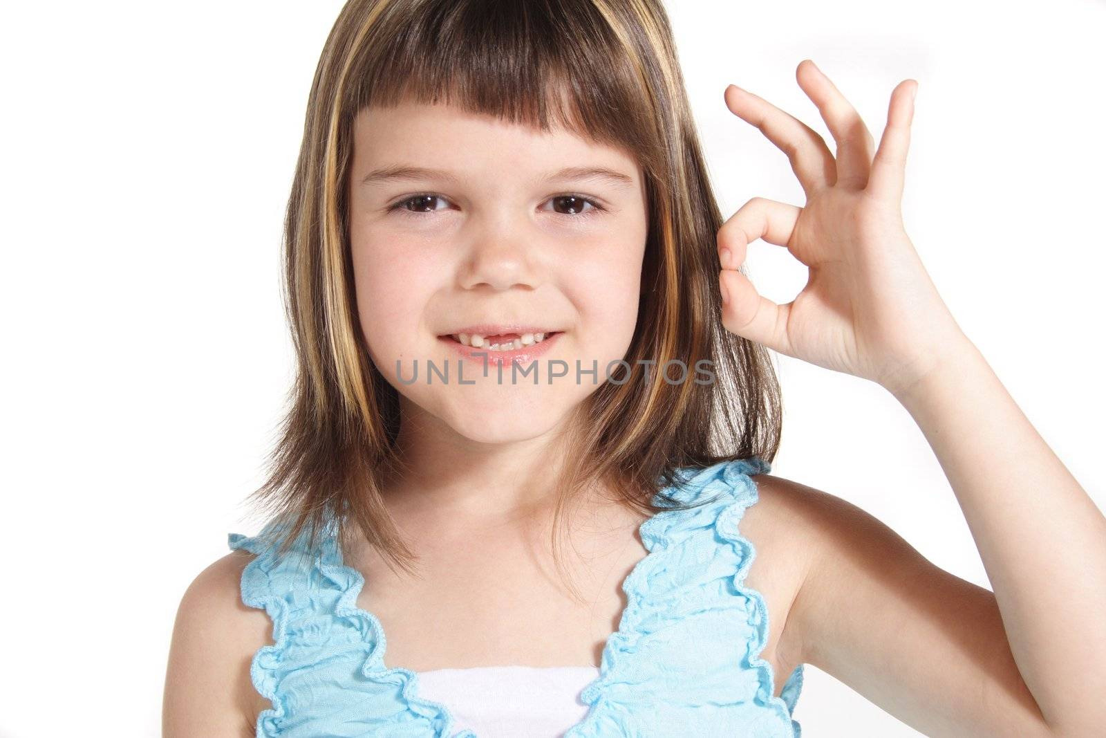 A young girl makes a positive gesture. All isolated on white background.