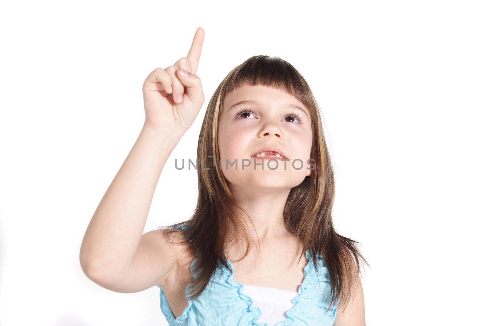 A young girl pointing at something. All isolated on white background.