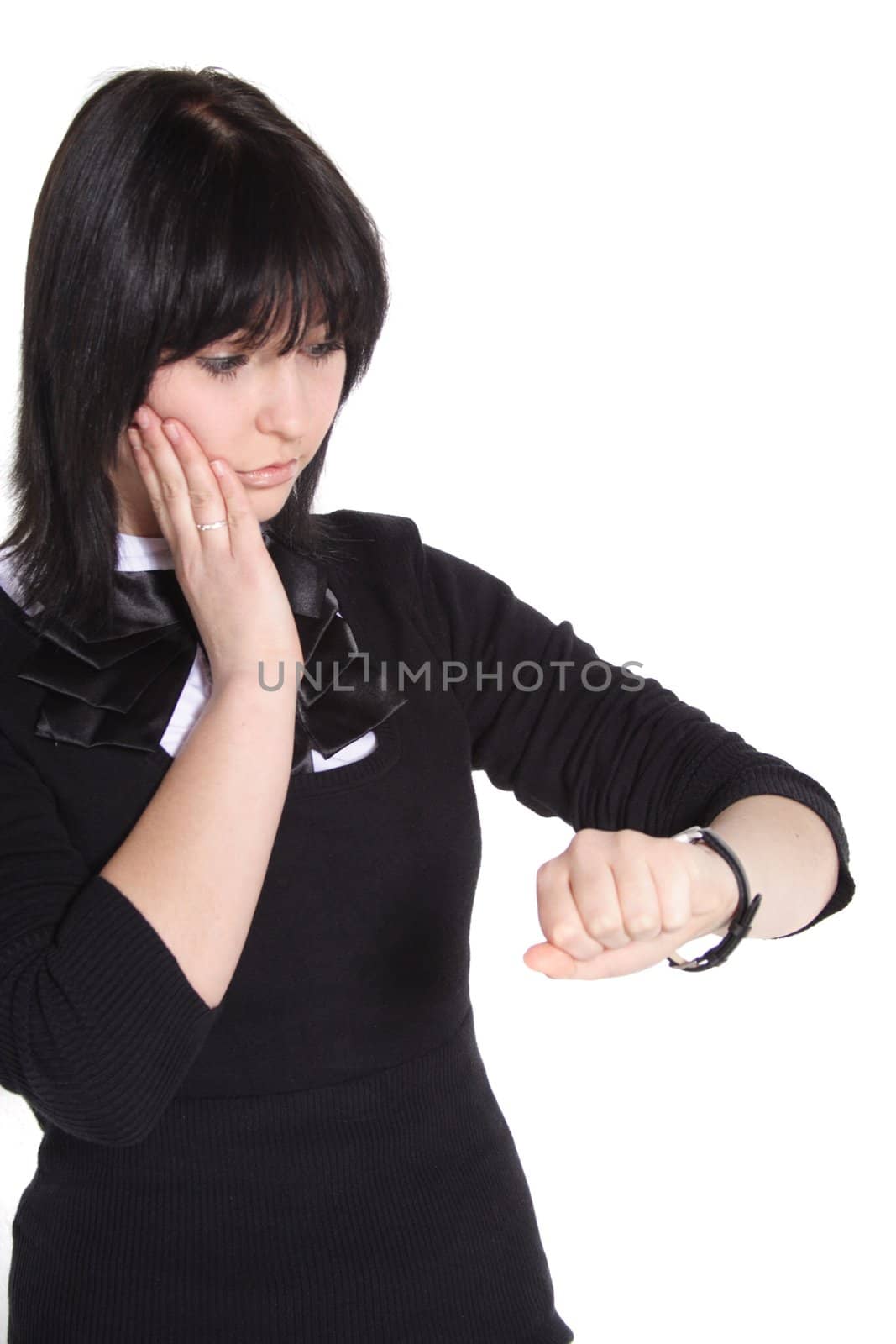 A handsome young woman looking at her watch. All isolated on white background.