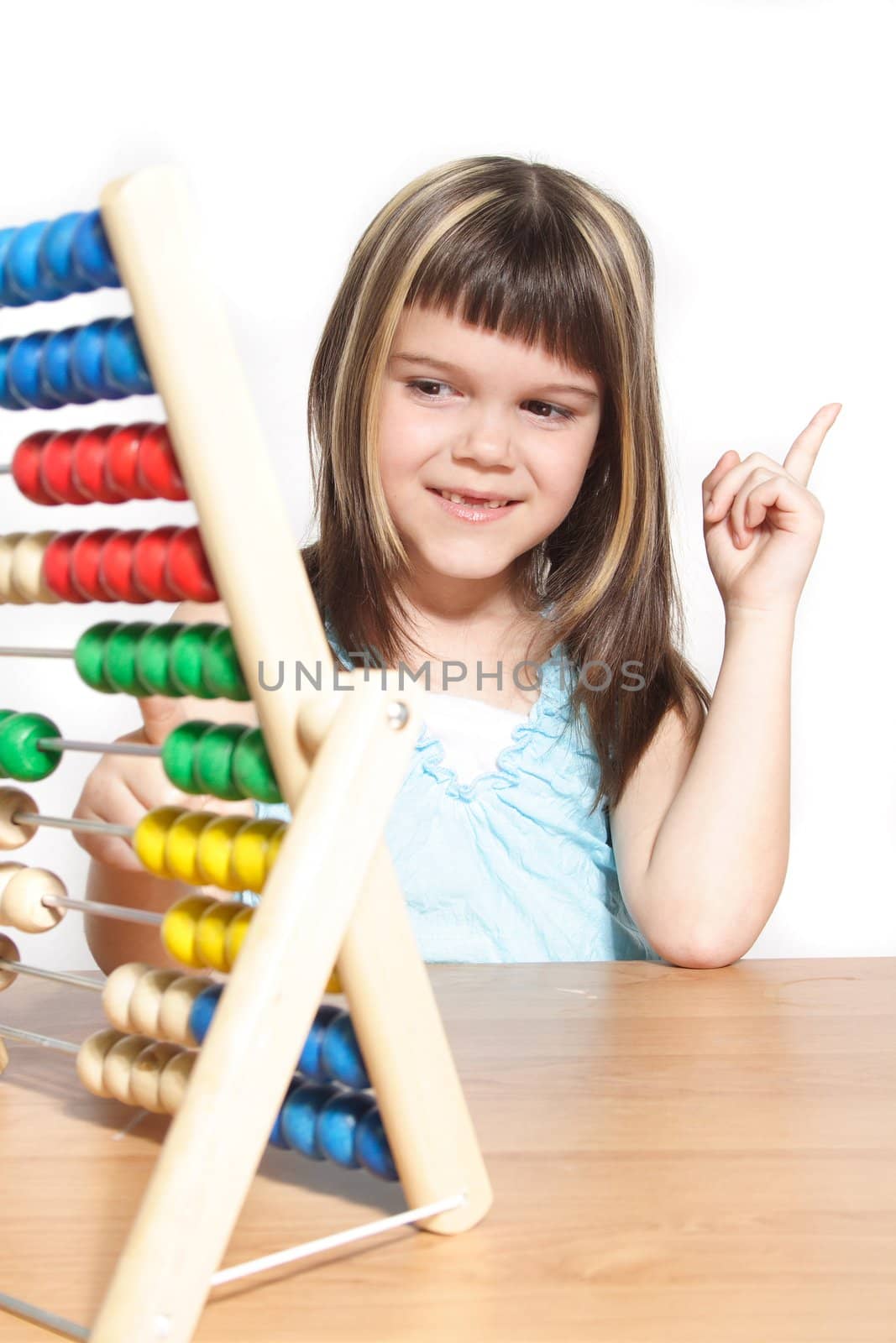 A young girl learning maths by using a sliding rule. All isolated on white background.