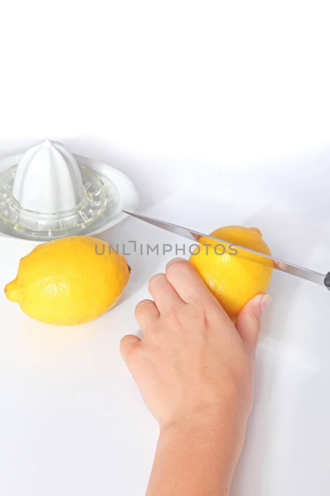 A person cutting lemons. All isolated on white background.