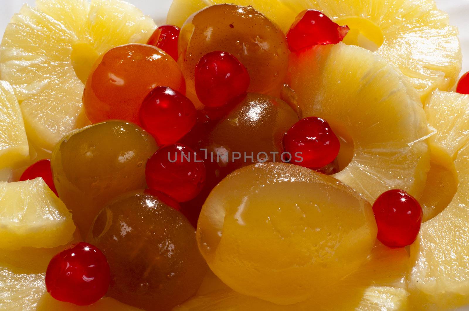 slices of pineapple and peach in the background