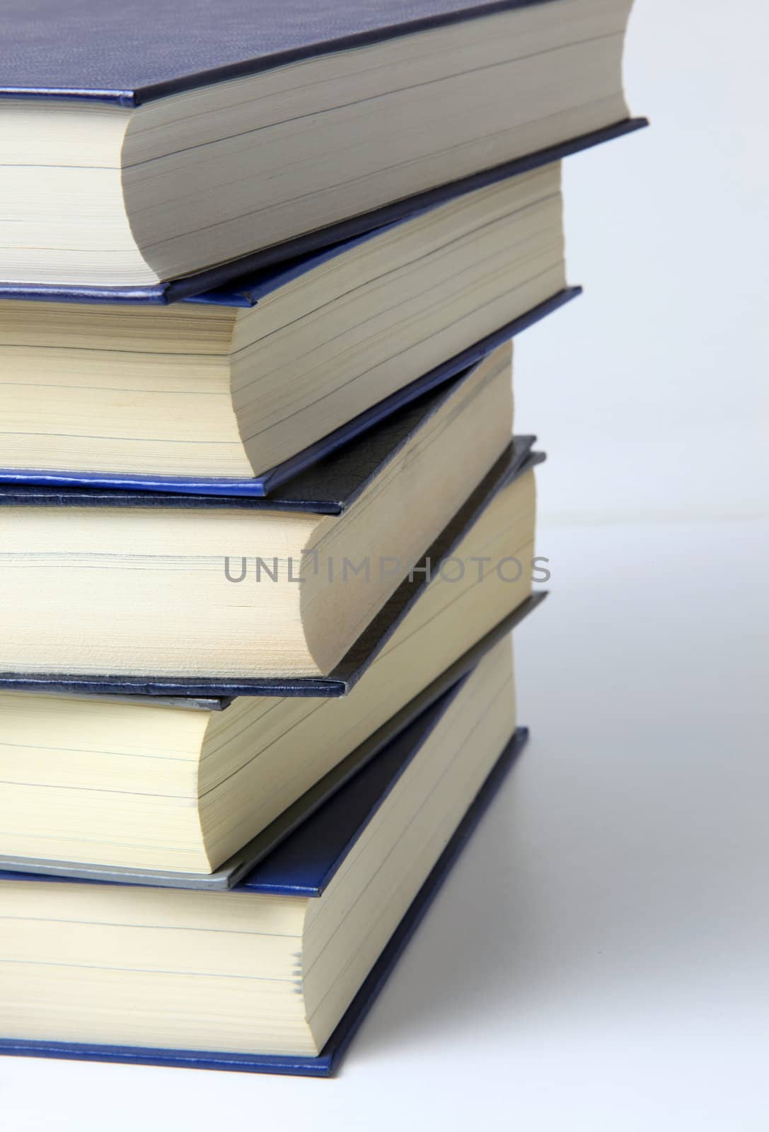 Several books lying one upon another. All on white background.