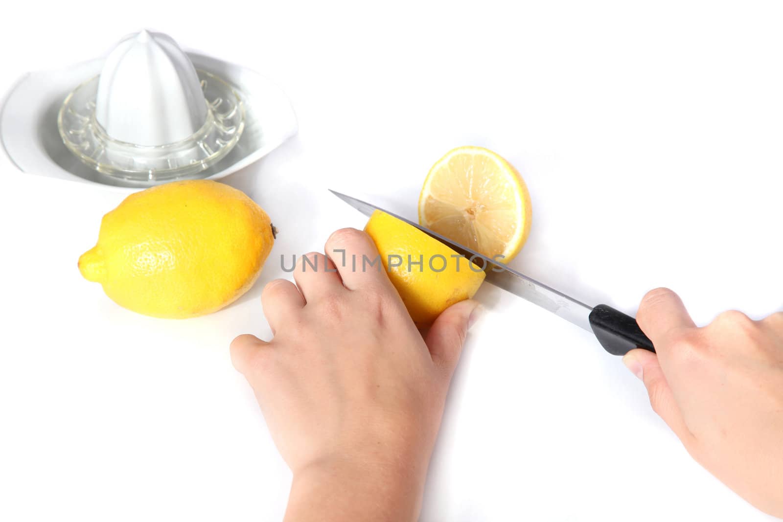 A person cutting lemons. All isolated on white background.
** Note: Shallow depth of field.