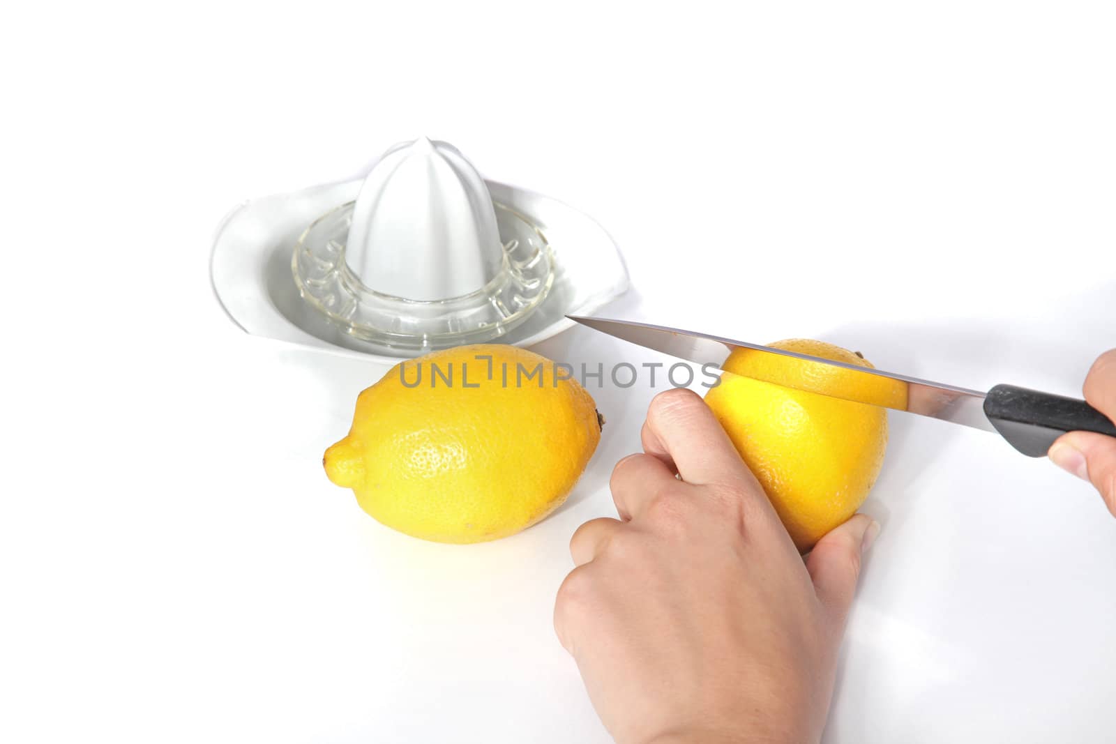 A person cutting lemons. All isolated on white background.
** Note: Shallow depth of field.