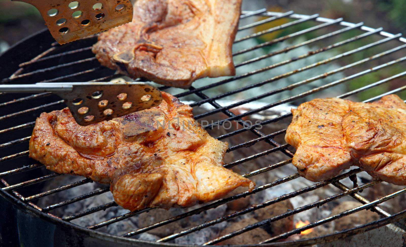 A nice grill barbecue with delicious marinaded steaks.