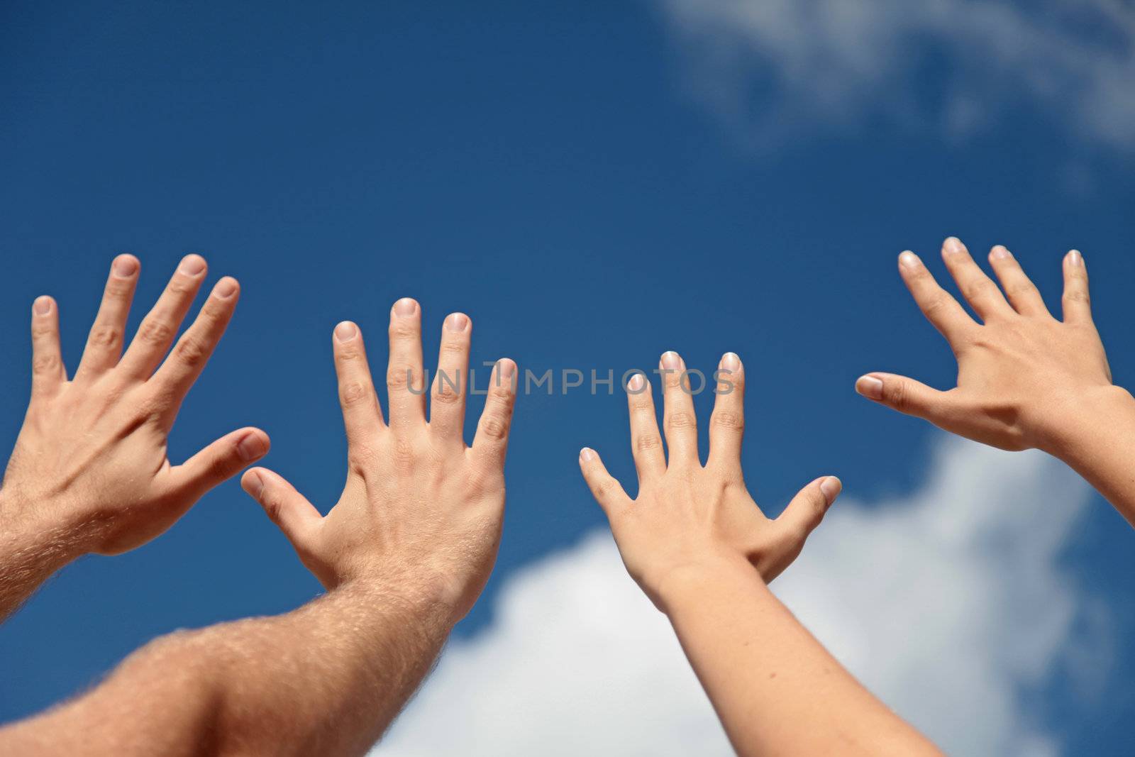 Two persons lifting their hands up in the air.