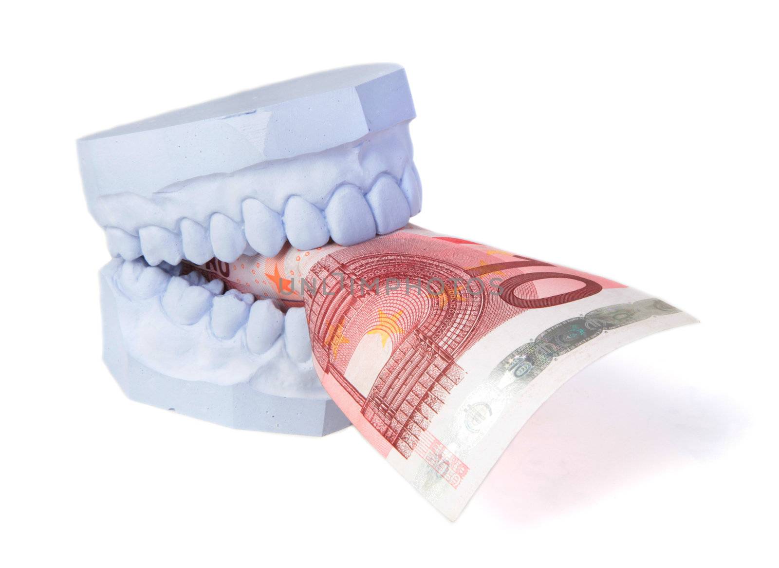 A set of teeth with some money. All isolated on white background.