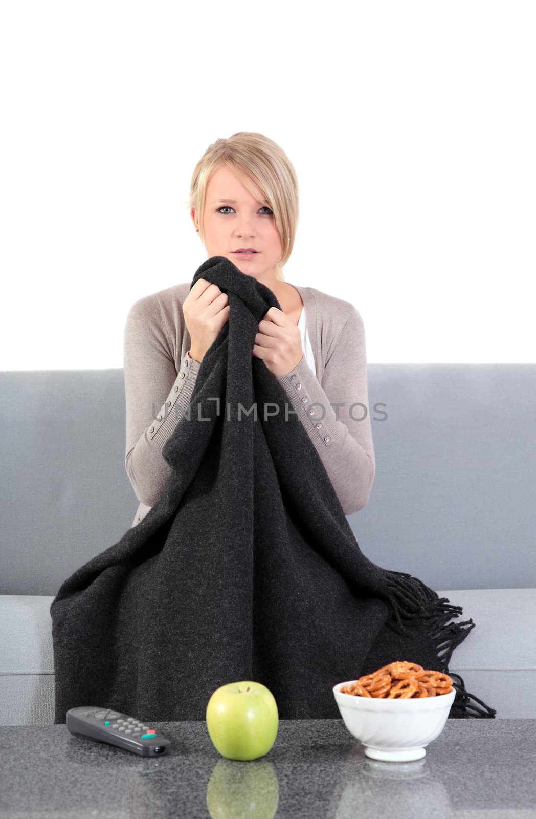 An attractive young woman is watching a thrilling movie at home.
** Note: Slight blurriness, best at smaller sizes.