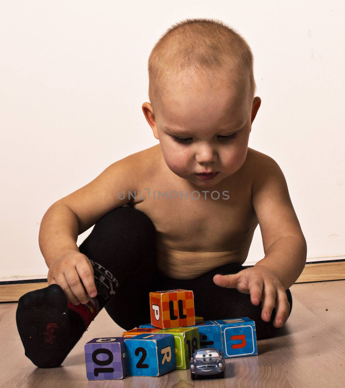 busy little boy is playing blocks