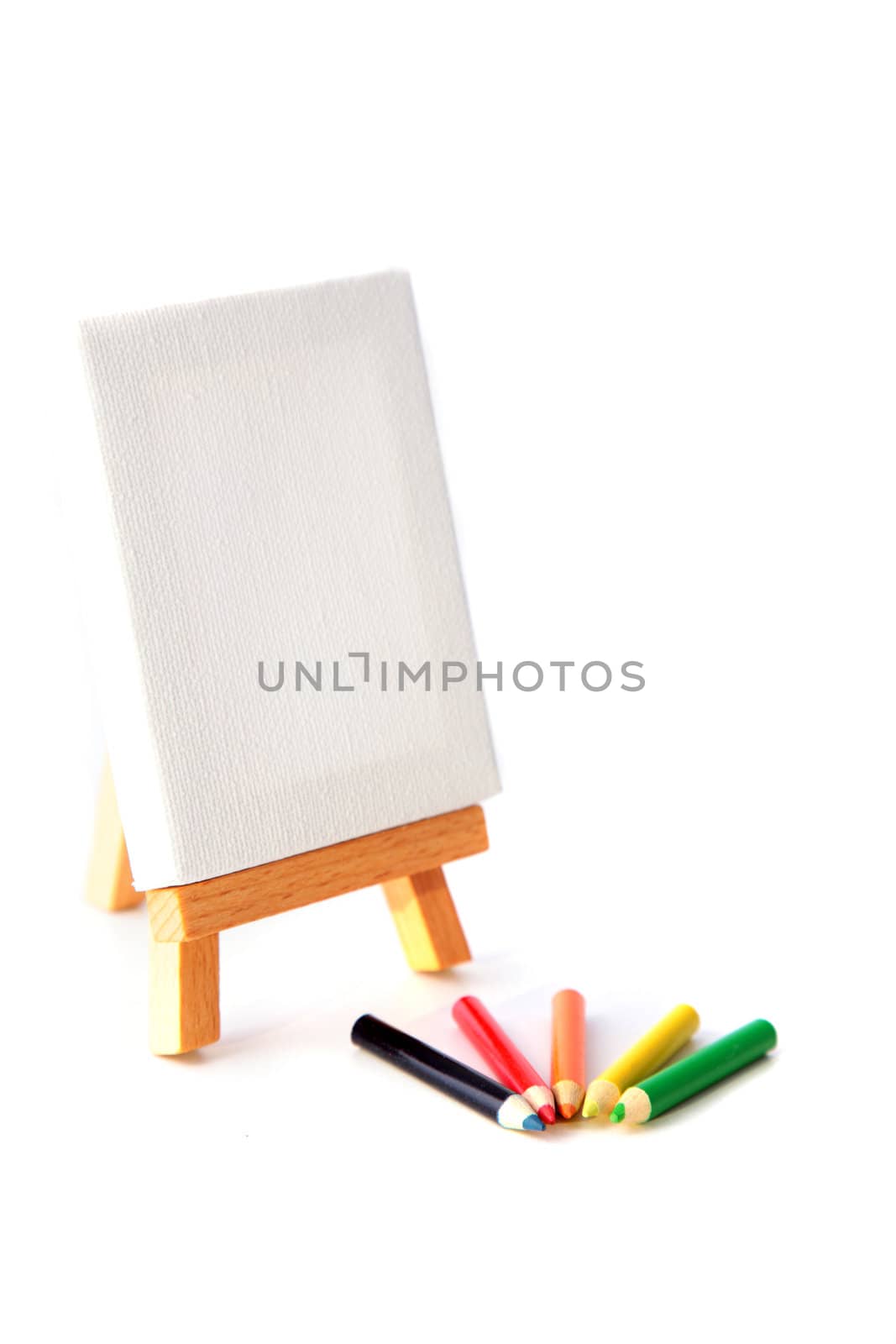 Several colorful pencils lying next to a scaffold. All on white background.