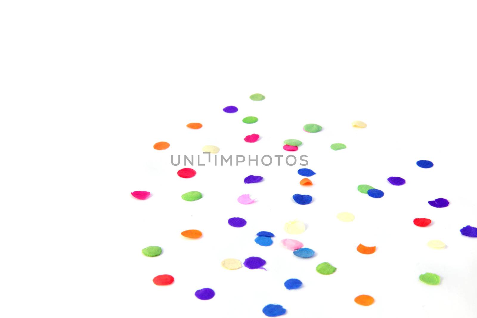 Some confetti lying on a plain white background.