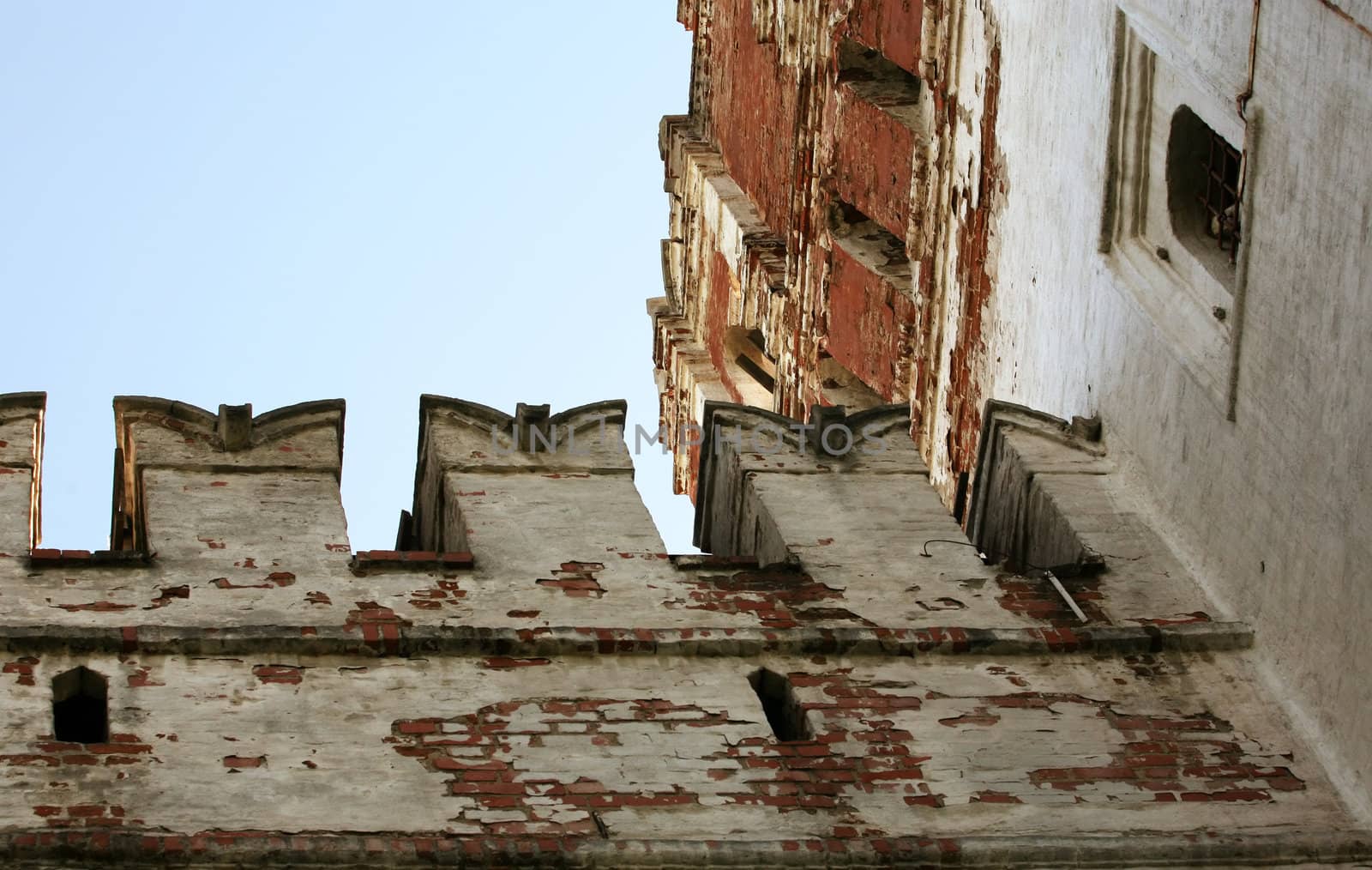 Fragment of old brick wall with white stucco
