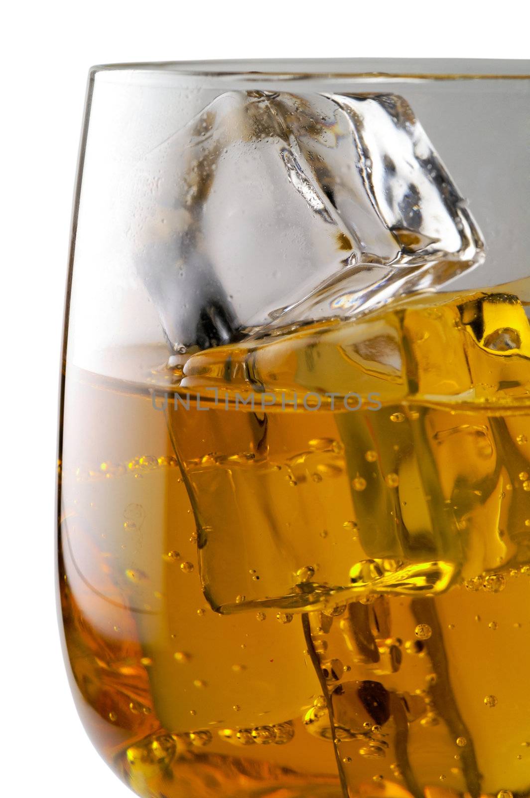 Glass of yellow drink with ice closeup (C4) clipping path