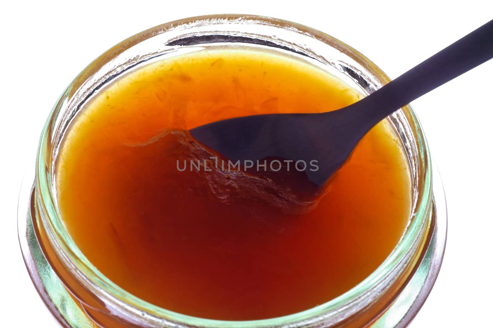 Apricot jam in jar closeup by Laborer