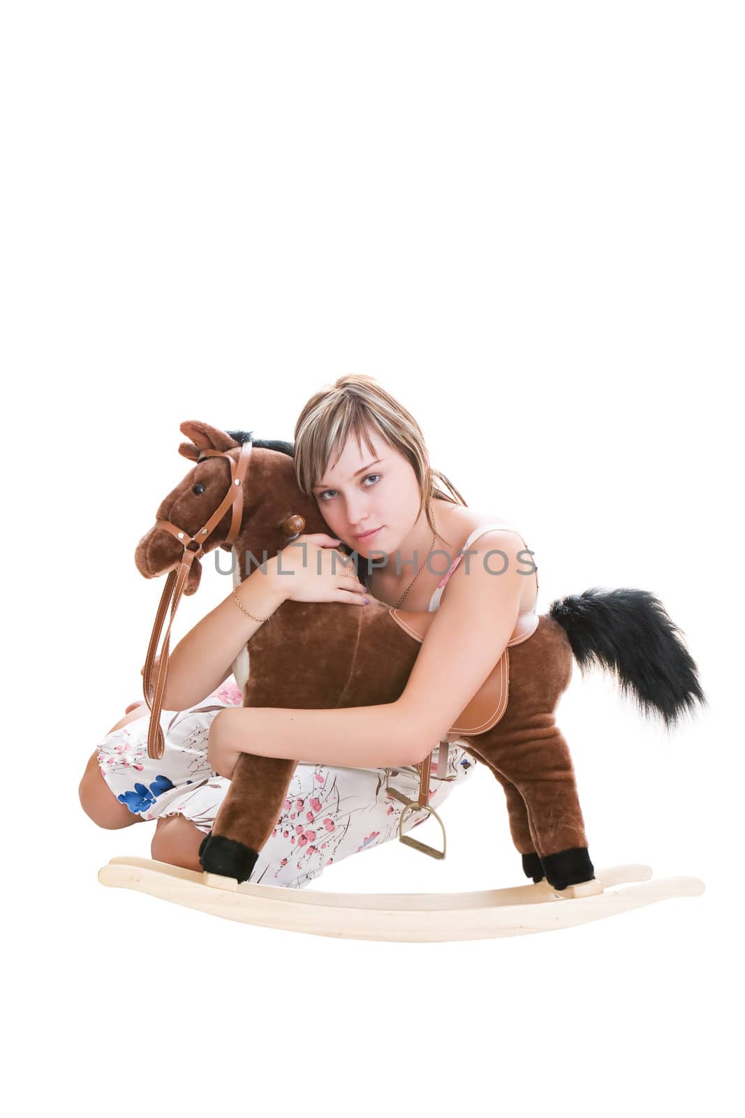 The girl embraces the toy horse