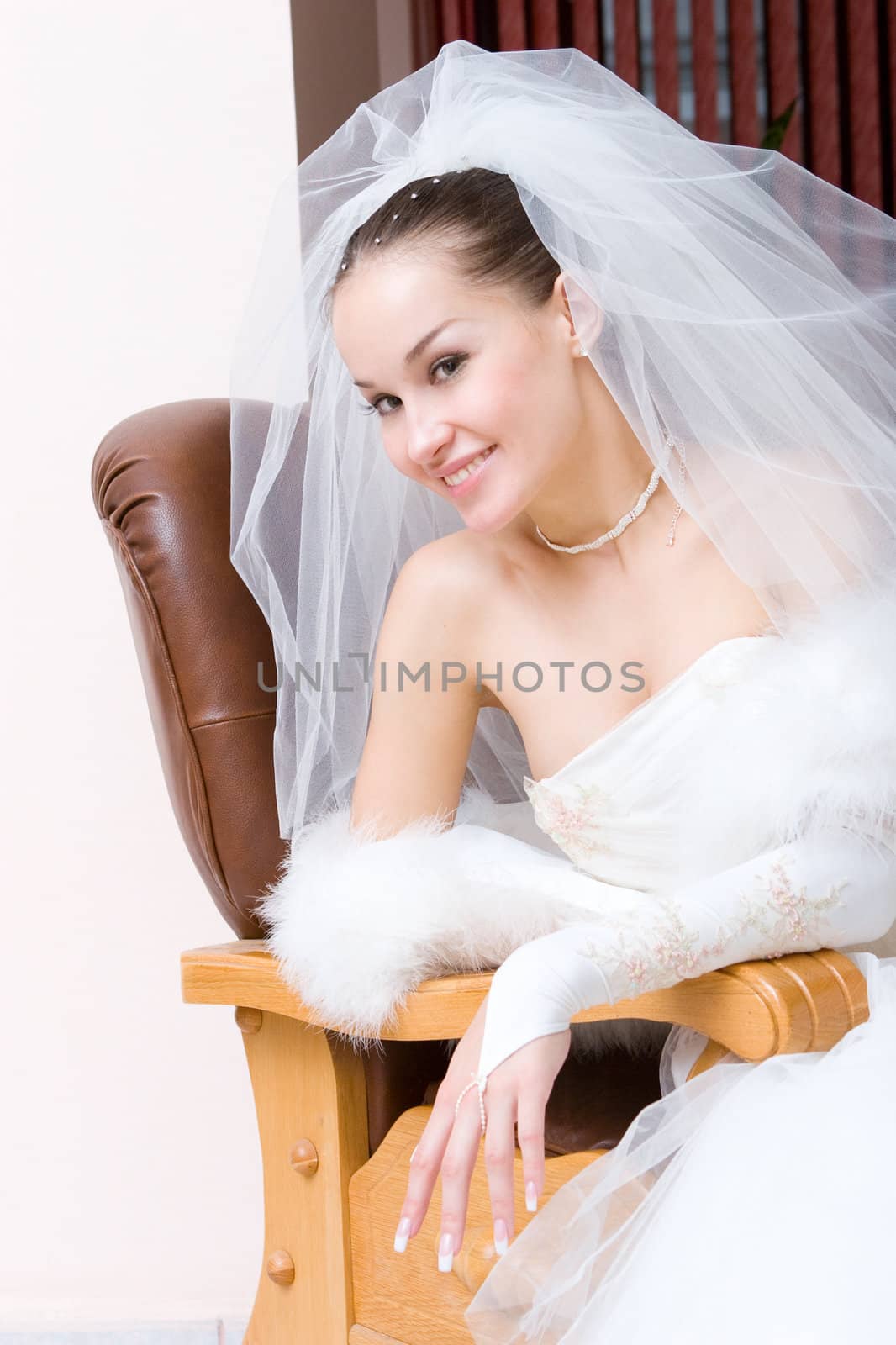 a beautiful smiling bride in a chair
