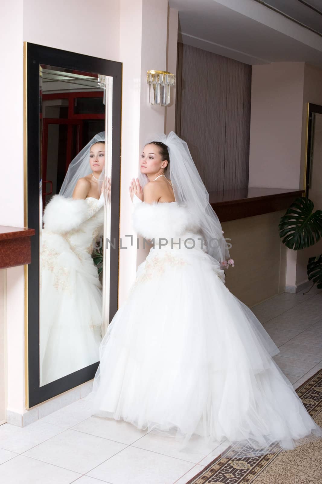 happy bride near the big mirror