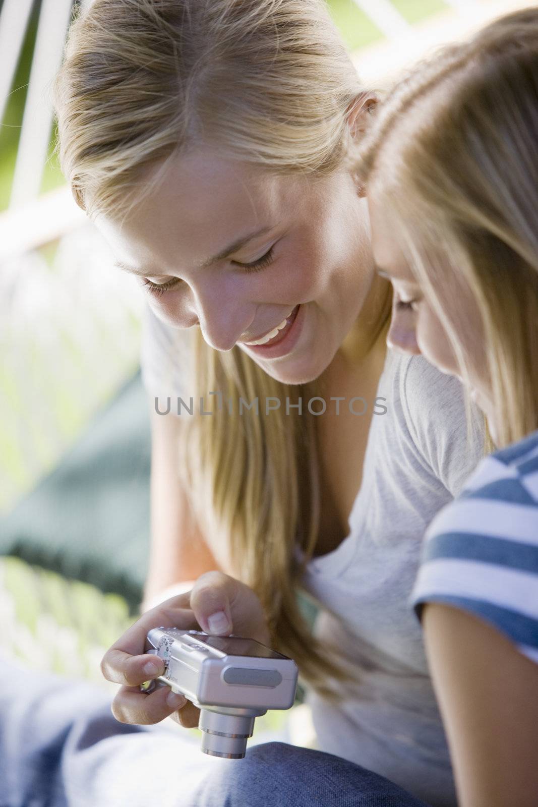 Teenage girls looking at pictures on the back of a digital camera