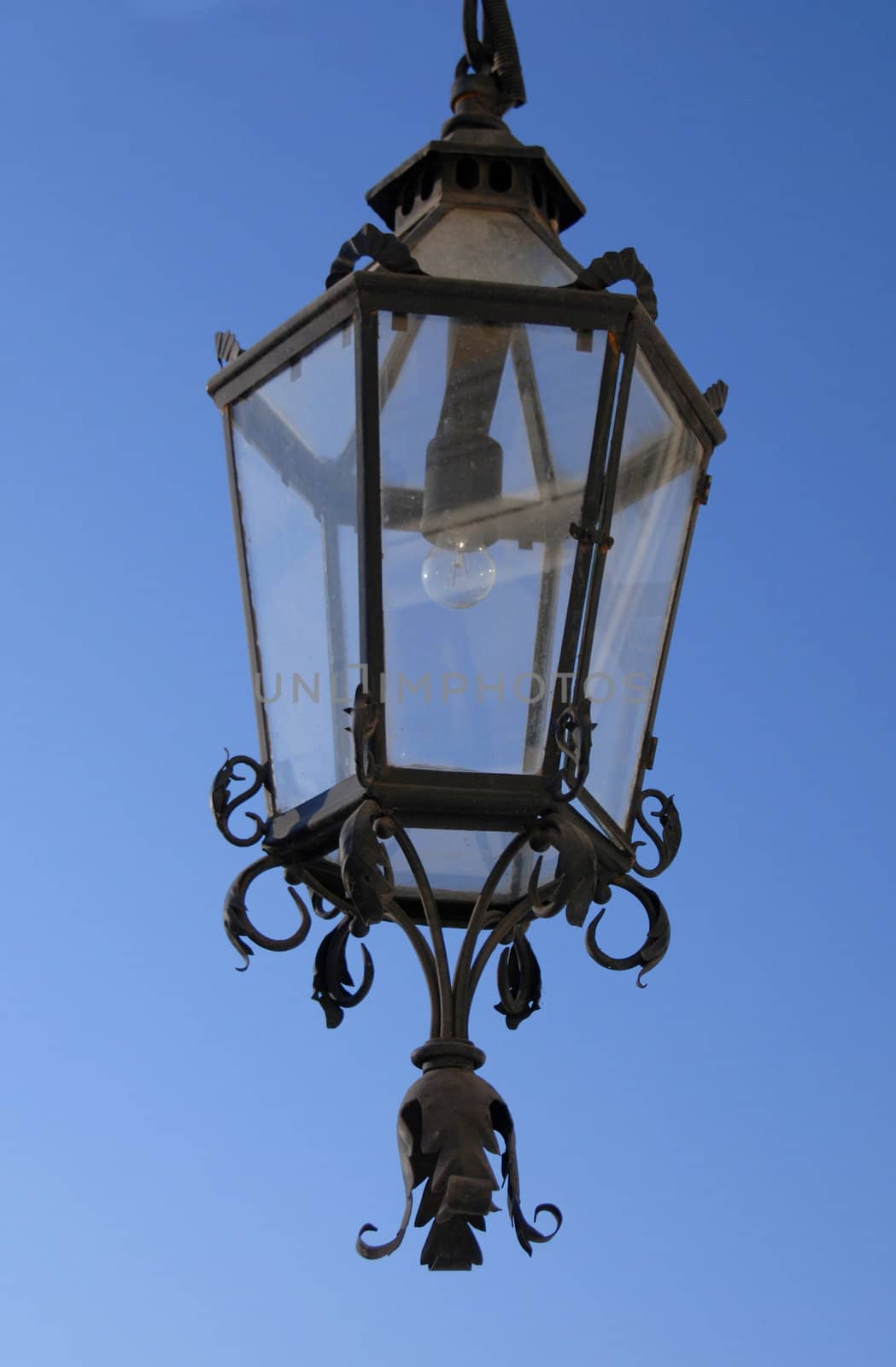 The old, off the lamp on a blue sky. by wojciechkozlowski