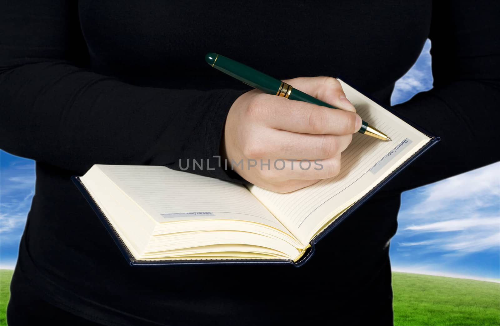 Female hand writing in a notebook by domencolja