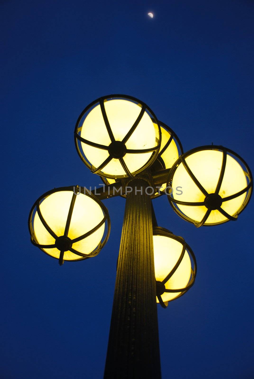 View of  antique street light against blue sky and moon. taken at singapore city in a beautiful evening