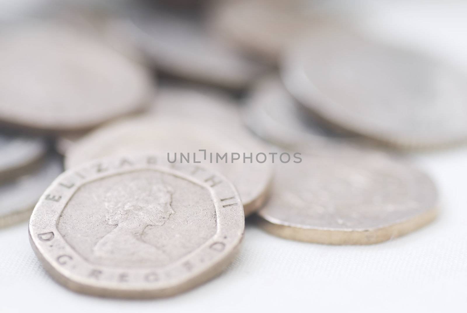 Spilled coins, focus on 20 pence coin. Sterling.