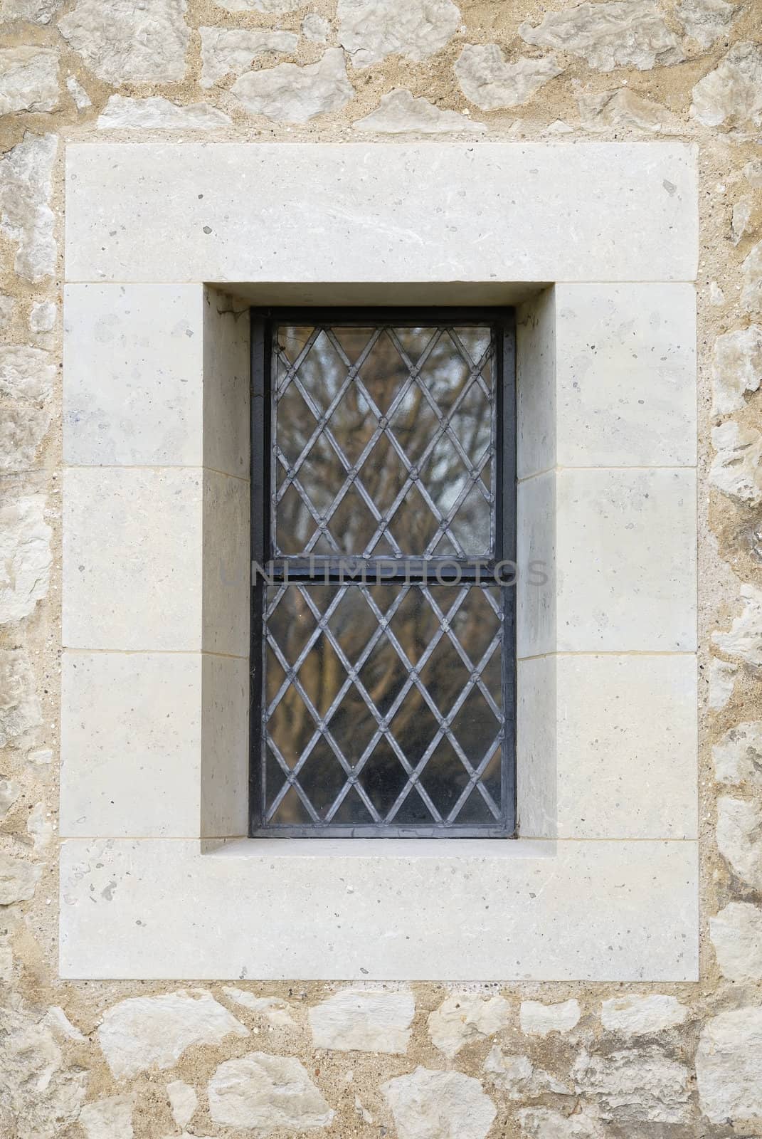 Central leaded Church window surrounded by stonework.