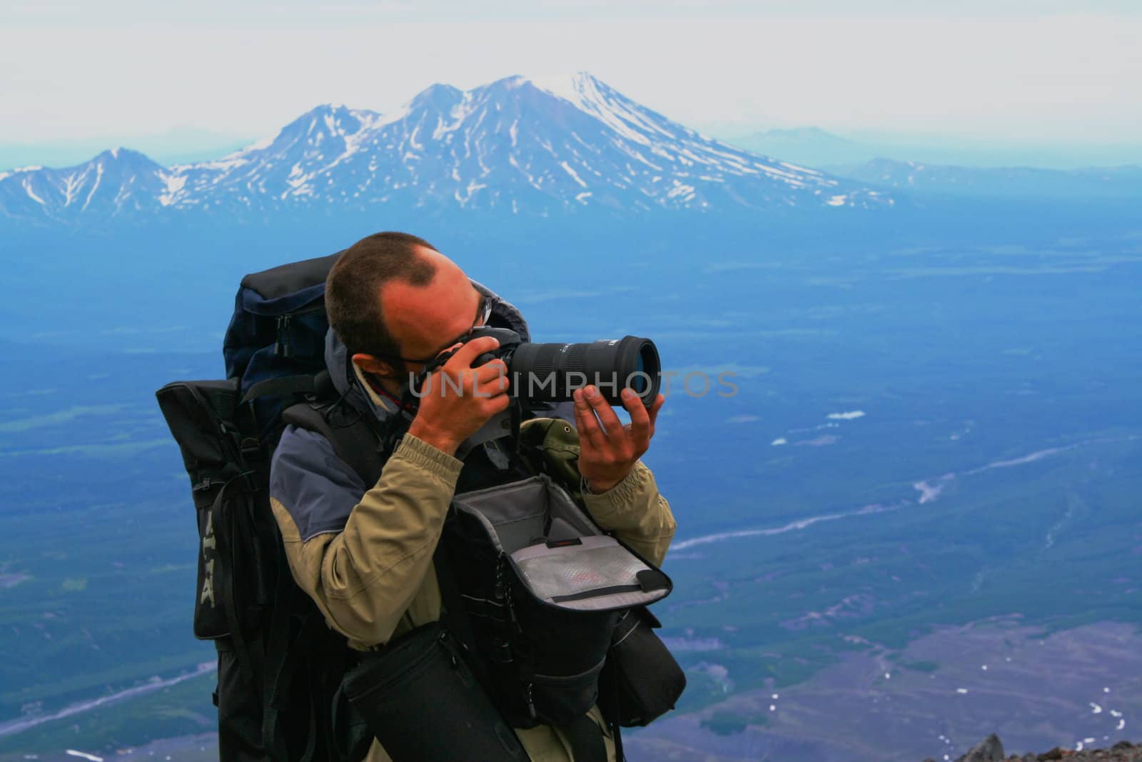 Photographer with equipment operates in expeditions; Kamchatka