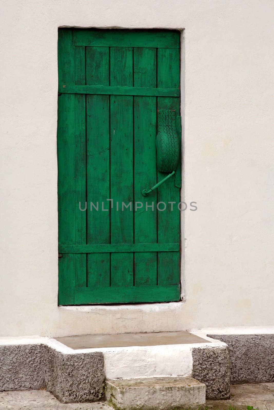 Green door in white wall